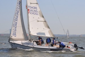 A Colgate 26 sailboat with 4 students and instructor