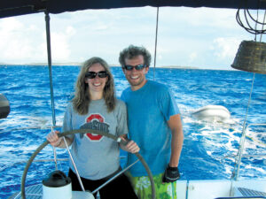 Couple learning to bareboat charter a sailboat