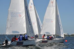 Colgate 26 sailboats with Performance Race Week participants at start of a sailboat regatta.