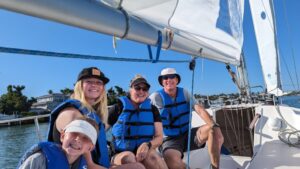 family learning to sail aboard a Colgate 26 sailboat