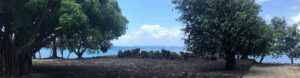 Tahiiti ancient stone ruins with boats in background