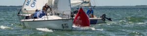 Two sailboats going around a racing mark