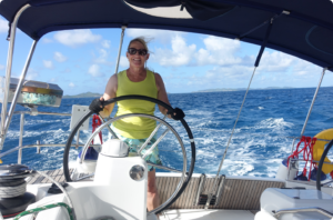 Woman steering a big sailboat